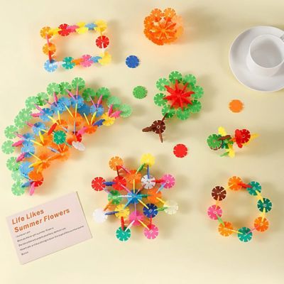 Flocons de construction Montessori SnowiBuild formant des fleurs et structures colorées, jeu éducatif créatif développant imagination et motricité fine